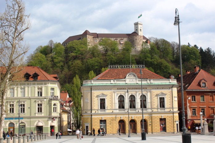 Academia Philharmonic (middle building) in Congress Square and Ljubljana Castle on the hill-top
