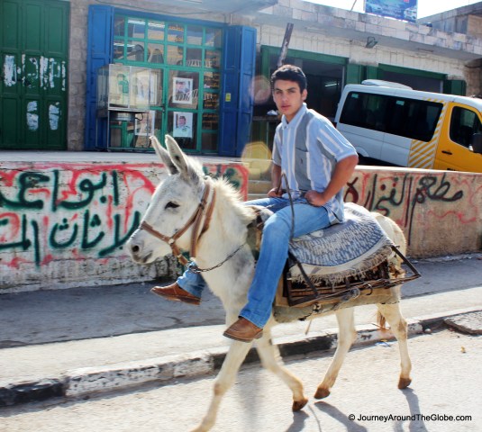 A donkey-rider on the street of Bethlehem