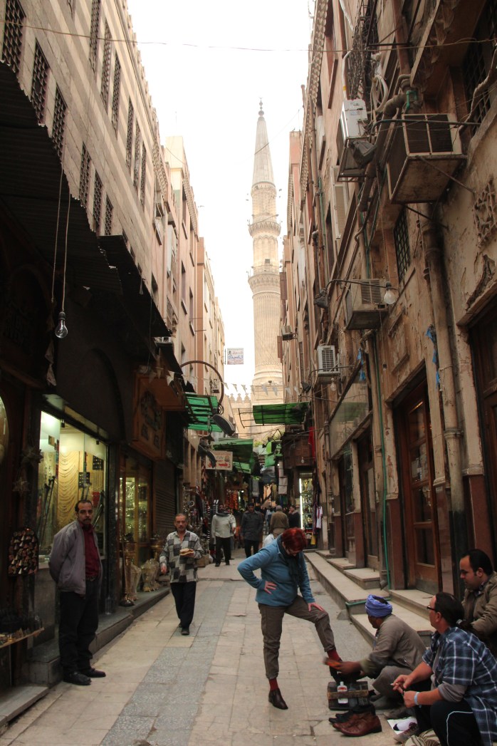 A woman polishing her shoes in Khan El-Khalili Bazar