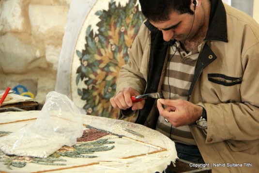 An artist working on a mosaic decor in Madaba Handcrafts Center, Jordan
