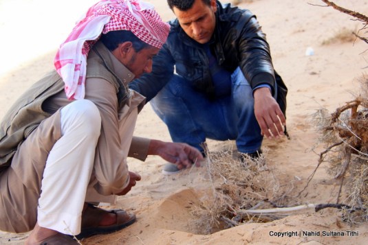 Our Bedouin guide is trying to lit the fire up to cook our lunch