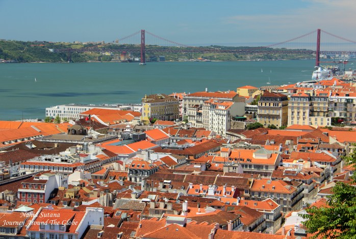 View of River Tagus, Bridge 25th April, and Alfama neighborhood in Lisbon, Portugal