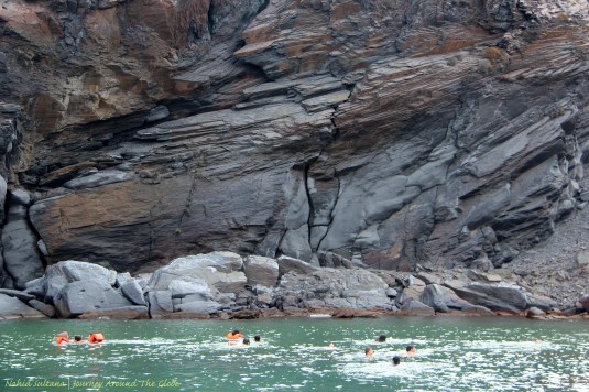 People swimming in the hot springs of Palea Kamini in Santorini