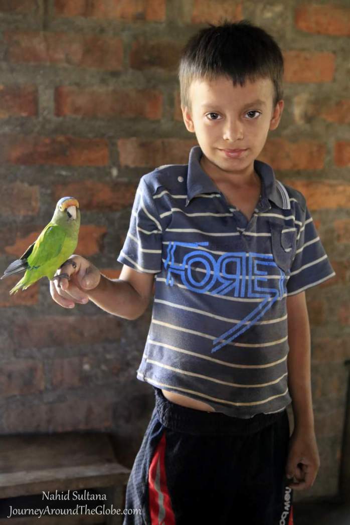 A little boy I met in Wasapa, with his pet parrot...Wasapa, El Salvador