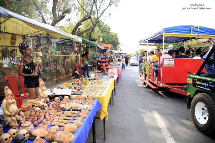 Street full of souvenir shops with full trinkets outside Tazumal Archeological Park in El Salvador