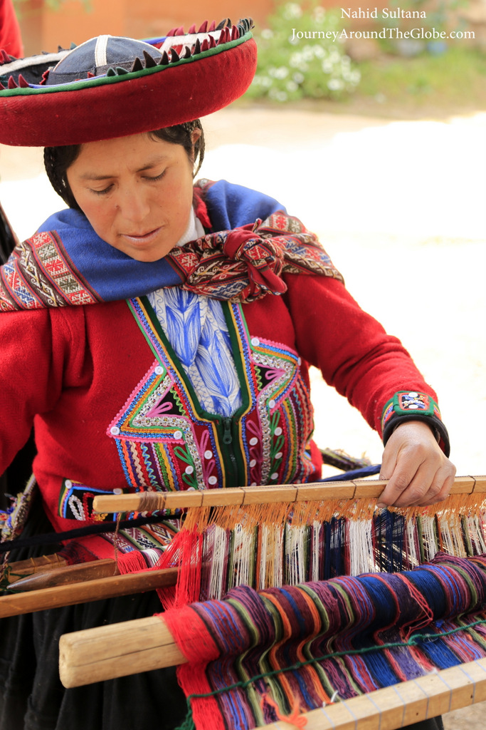 A weaver working with alpaca wool at Figueroa Alpaca Textile in Peru