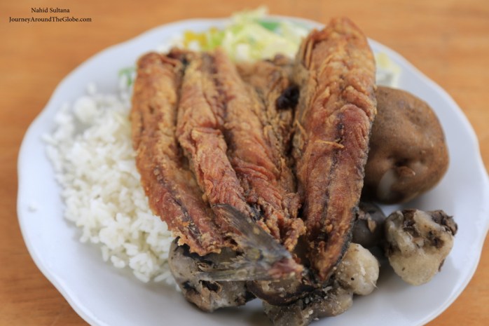 Fried trout with rice, boiled potato, and veges in Chinchero market, Peru