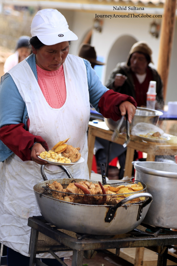 A lady in Chinchero market selling street food